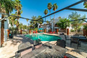a patio with a swimming pool with chairs and a table at 37B- Casa Grande Condo full remodel w HEATED POOL in Casa Grande