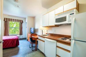 a small kitchen with a sink and a refrigerator at Sierra Vista studio apartment with full kitchen and King Bed in Sierra Vista
