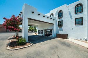 a large white building with a parking lot at Sierra Vista studio apartment with full kitchen and King Bed in Sierra Vista