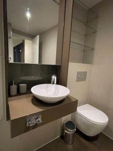 a bathroom with a sink and a toilet at Modern apartment w/ canal view in London