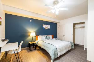 um quarto com uma cama e uma parede azul em Vistas 202- Modern Sierra Vista 1bd great location em Sierra Vista