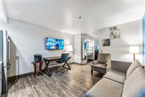 a living room with a couch and a table at Metro Tempe Extended Stay - King Studio in Tempe