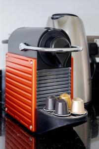 an orange and black toaster sitting on a counter at Stylish Apartment with Private Rooftop in Covent Garden in London