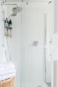 a bathroom with a shower with a glass door at Stylish Apartment with Private Rooftop in Covent Garden in London