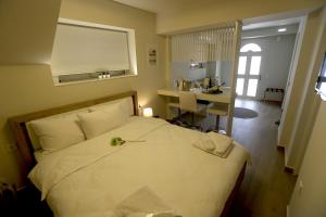 a bedroom with a bed and a desk in a room at Central Luxury Flat 1 in Chios
