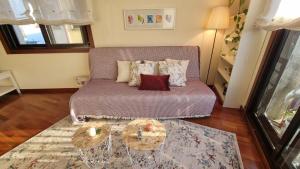 a living room with a couch and two tables at Apartamento 1 dormitorio 4 personas en El Grove in O Grove