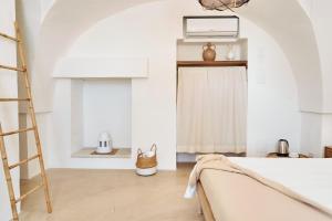 a white room with a ladder and a window at Il Trappetello in Monopoli