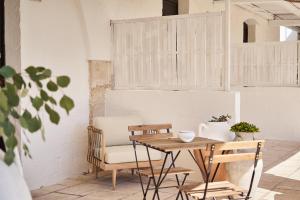 a table and chairs in a room with a chair at Il Trappetello in Monopoli