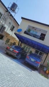 two cars parked in front of a building at Sammy's Place in Lekki