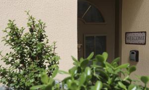 a door with a welcome sign and plants in front of it at Central Luxury Flat 1 in Chios