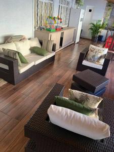 a living room with couches and pillows on the floor at Casa com Piscina em Região Nobre de Cascavel in Cascavel