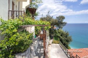 a house with a view of the ocean at Uranus Blue Residence Agios Ioannis Papa Nero in Agios Ioannis Pelio