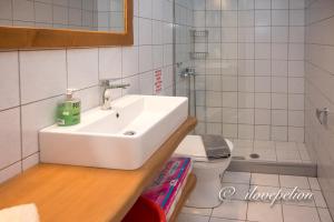 a bathroom with a sink and a toilet at Uranus Blue Residence Agios Ioannis Papa Nero in Agios Ioannis Pelio