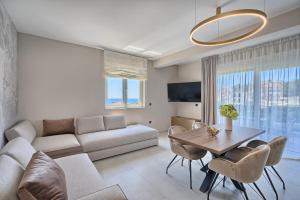 a living room with a couch and a table at Residence Franc 2 in Primošten
