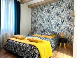 a bedroom with two beds and a large wall at Sara Home in Chennevières-sur-Marne