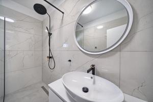 a white bathroom with a sink and a mirror at Residence Franc 2 in Primošten +42 photos