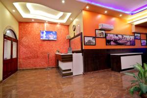 a room with an orange wall with a counter at TRPOTELS Town Inn in Gwalior