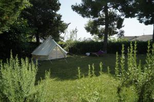a white tent in the middle of a yard at Rifugio tra gli alberi in Atri