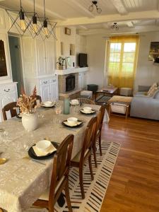 a living room with a table with chairs and a living room at La Teyssière in Bar-sur-Seine +27 photos