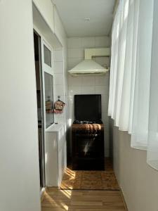 a hallway with a room with a tv and a window at Your sweet home in Tashkent in Tashkent
