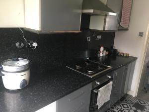 a kitchen with a stove and a counter top at Good Things Come in Small Packages in Manchester