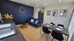 a living room with a table and a blue couch at Apartments Amare in Kali