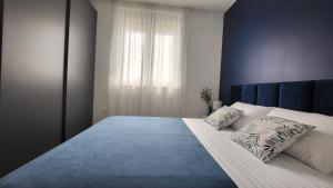 a bedroom with a large bed with two pillows at Apartments Amare in Kali +41 photos