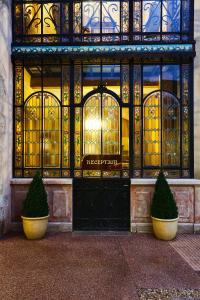 a building with two bushes in front of a door at Hotel Belle Epoque in Beaune