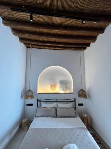 a bedroom with a large bed with a wooden ceiling at Casa Stergia - Village Project in Psinthos