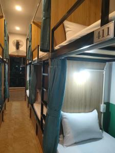 a bunk bed in a room with a bed in a room at Nineties homestay in Hue