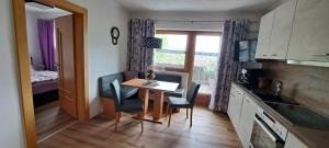 a small kitchen with a table and chairs in a room at Ferienwohnung Steinberger in Hippach