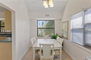 a dining room with a white table and chairs at Captiva Beach Bungalow on Turner Beach in Captiva +23 photos