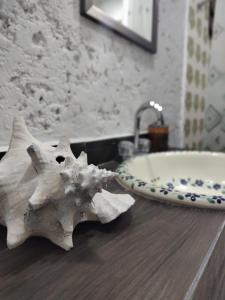 a starfish sitting on a bathroom counter next to a sink at ON THE BEACH SURFERS SUNRISE HAVEN 2 in Cancún