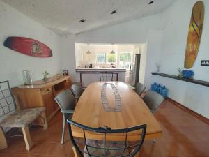 a dining room with a wooden table and chairs at ON THE BEACH SURFERS SUNRISE HAVEN 2 in Cancún