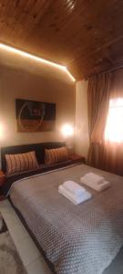 A bed or beds in a room at Erodios Guesthouse
