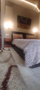 A bed or beds in a room at Erodios Guesthouse