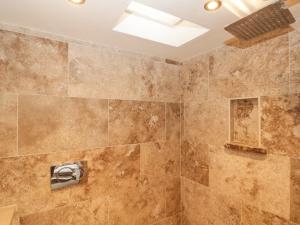 a bathroom with a large shower with a skylight at Northcot in Scarborough