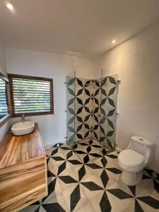 a bathroom with a toilet and a sink at El Pital, Chocolate Paradise in Balgue