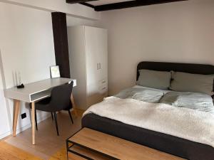 um quarto com uma cama, uma secretária e uma mesa em Traumschönes Fachwerk in Hamelns Altstadt em Hameln