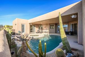 a house with a swimming pool and cactus at Serenity Peaks- Gorgeous Pet Friendly Villa in Scottsdale with Pool, Spa, and Bikes in Scottsdale