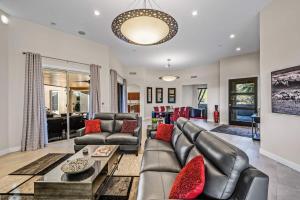a living room with a couch and a table at Serenity Peaks- Gorgeous Pet Friendly Villa in Scottsdale with Pool, Spa, and Bikes in Scottsdale