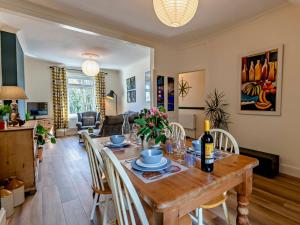 a dining room and living room with a table and chairs at 2 Bed in Totnes 94724 in Totnes