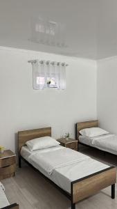 a bedroom with two beds and a window at Hostel,halal in Tokmok