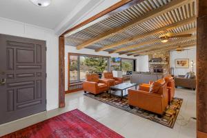 a living room with orange chairs and a brown door at Mid-century Ranch Home in Sedona with Fantastic Red Rock Views in Sedona