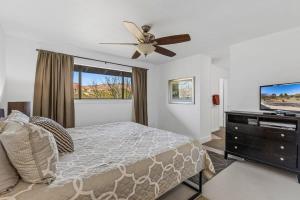 a bedroom with a bed and a ceiling fan at Mid-century Ranch Home in Sedona with Fantastic Red Rock Views in Sedona