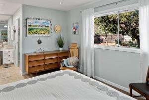 a bedroom with a bed and a dresser and a window at Gorgeous West Sedona Home with Red Rock Views in Sedona