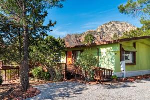 a green house with a mountain in the background at Gorgeous West Sedona Home with Red Rock Views in Sedona
