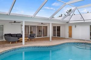 a house with a swimming pool and a patio at Sanibel Serenity- NEW Gorgeous Near Beach Villa with Pool in Sanibel