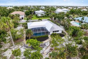 an aerial view of a house with palm trees at Sanibel Serenity- NEW Gorgeous Near Beach Villa with Pool in Sanibel