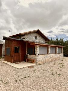 a stone house with a front door and aphalt at Crown Luxurious Residence in Arachova